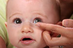 A Baby Trying a Contact Lens