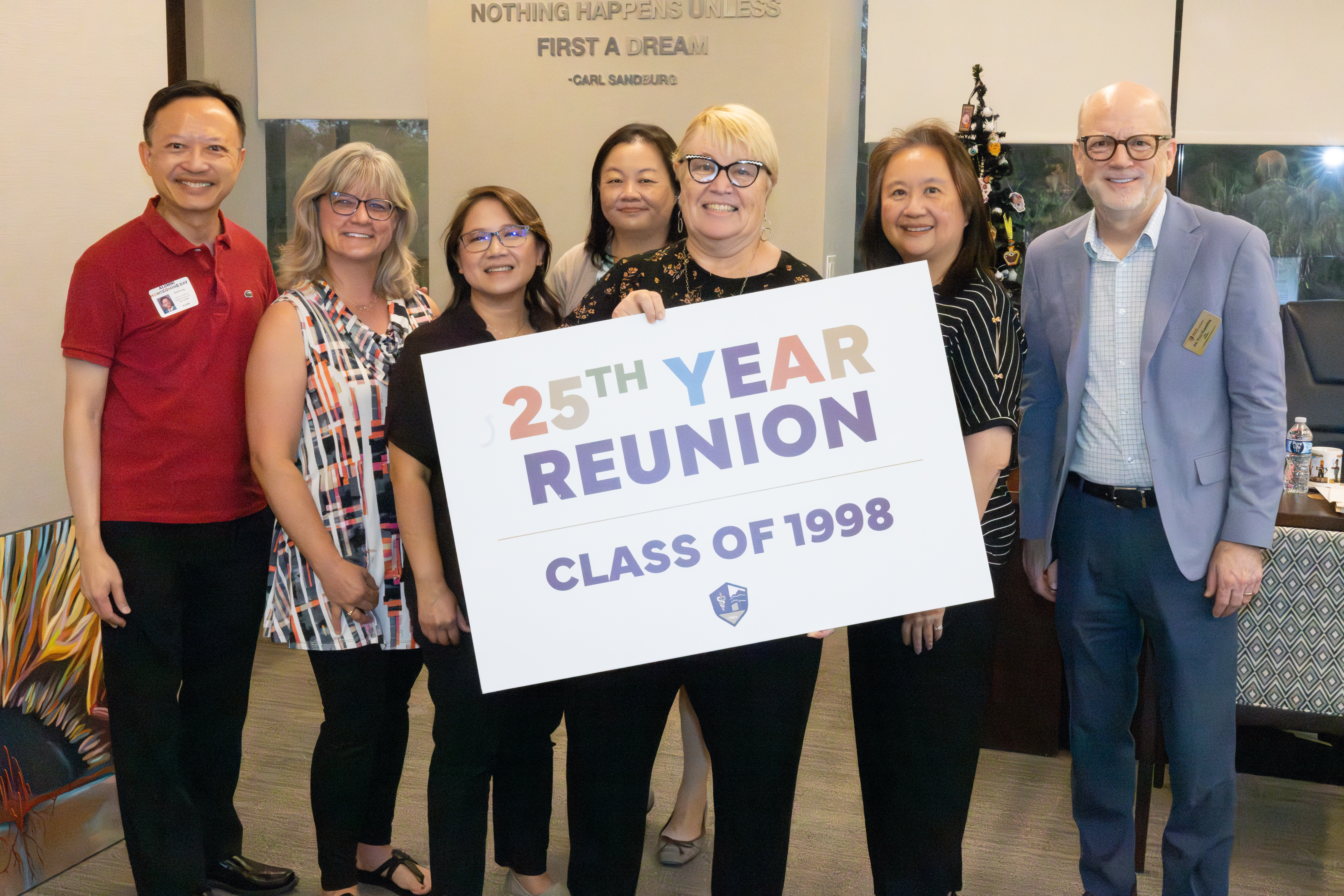 President Schornack poses with Class of 1998 reunion attendees