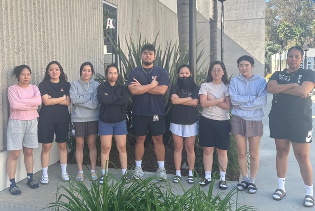 Photo of PA students standing in a row with their arms crossed