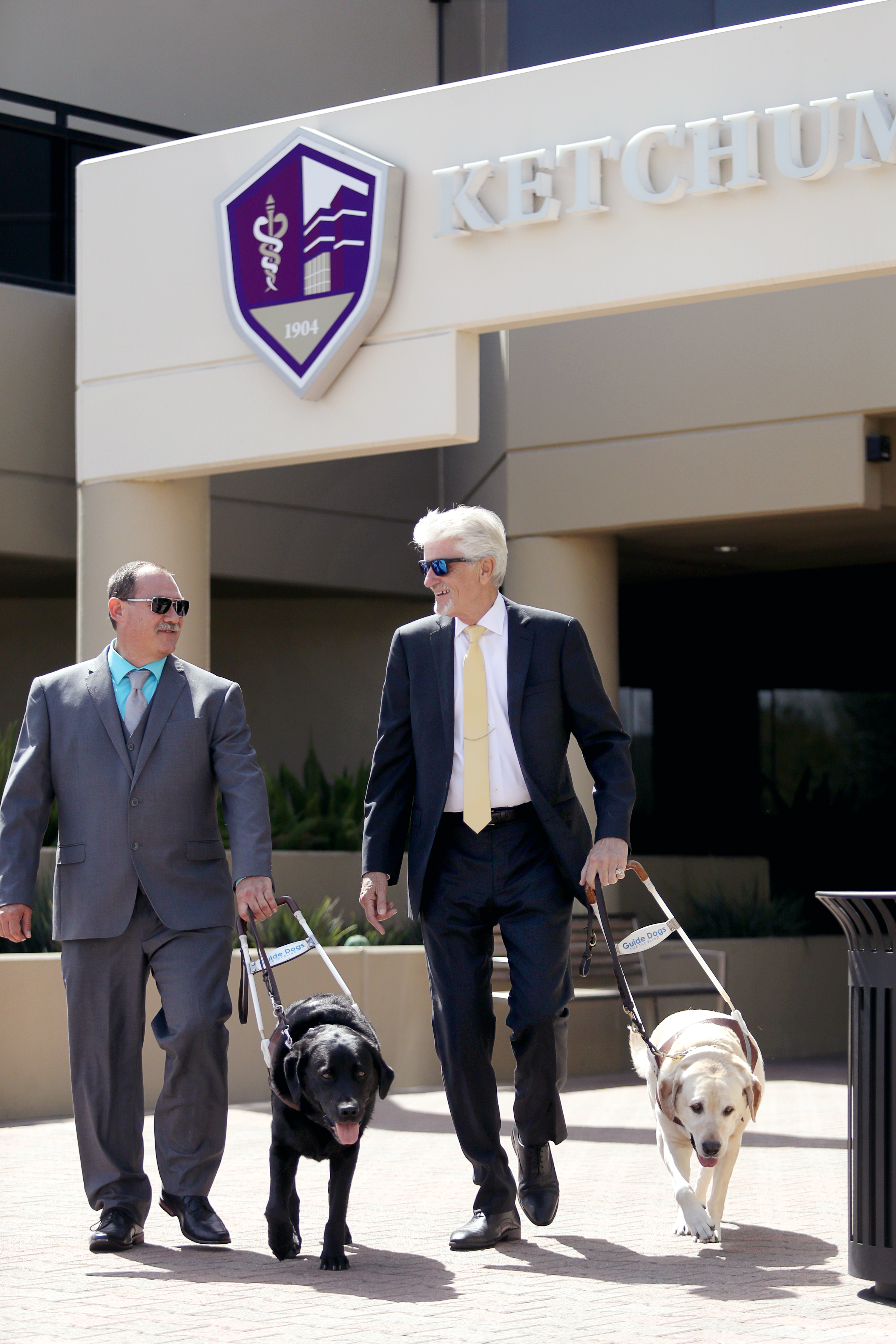 Mitch Grogan and Wayne Heidle walking with Poncho and Leon