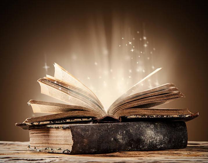 Image of book open with light pouring out of the book